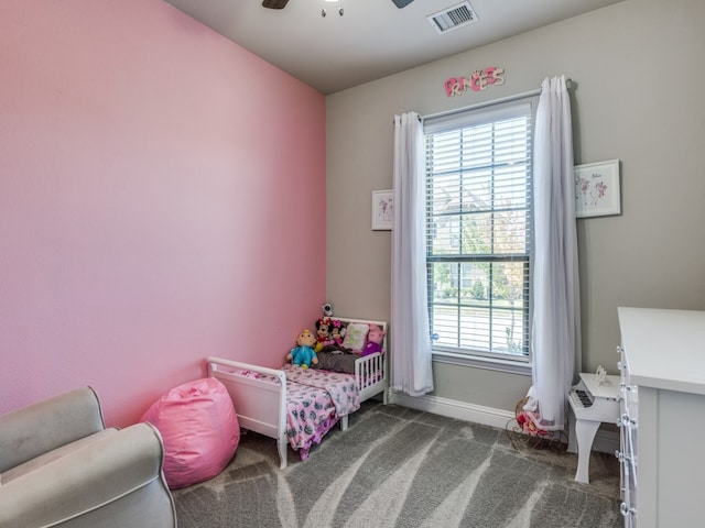 bedroom featuring dark carpet and ceiling fan