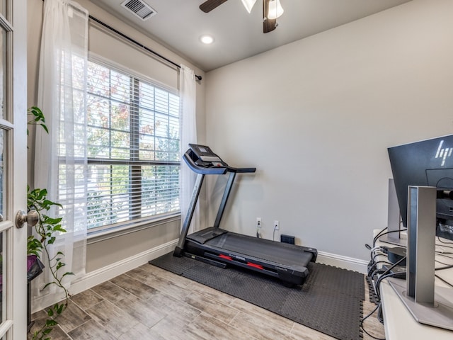 workout room featuring ceiling fan and hardwood / wood-style floors