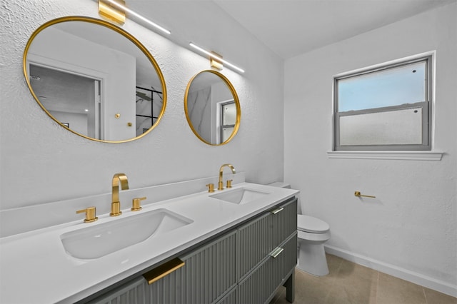 bathroom with tile patterned floors, vanity, and toilet