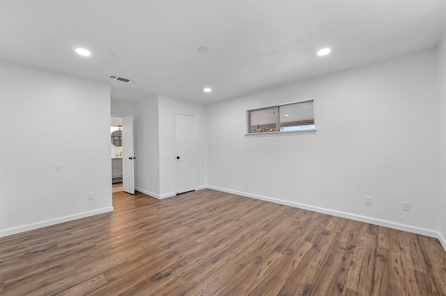 empty room with dark hardwood / wood-style floors