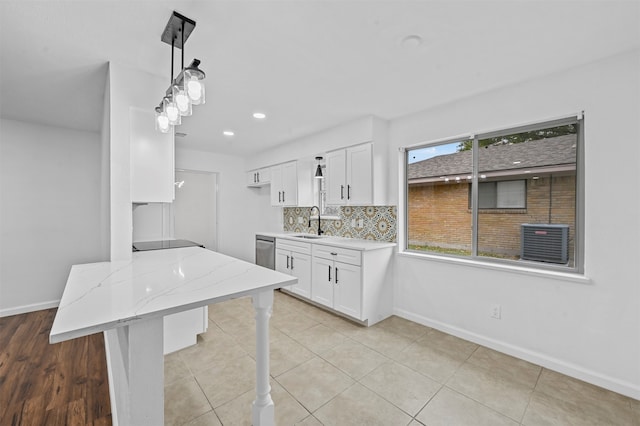 kitchen featuring white cabinetry, sink, a healthy amount of sunlight, and stainless steel dishwasher