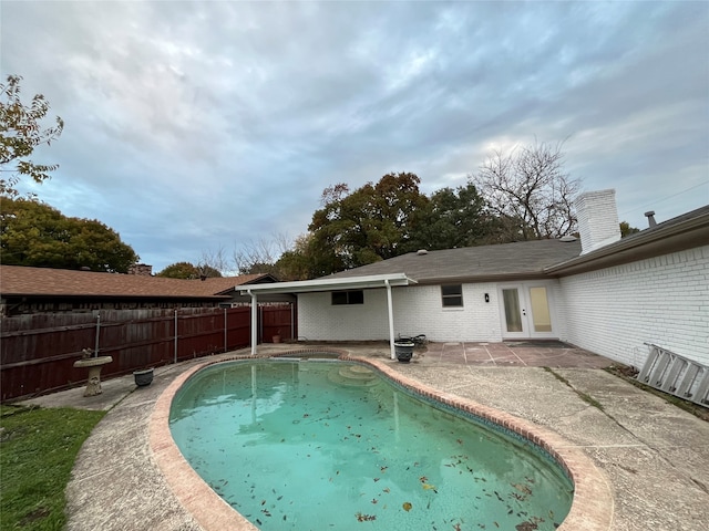 view of pool featuring a patio and french doors