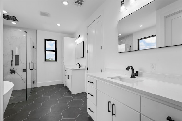 bathroom featuring tile patterned floors, vanity, and walk in shower