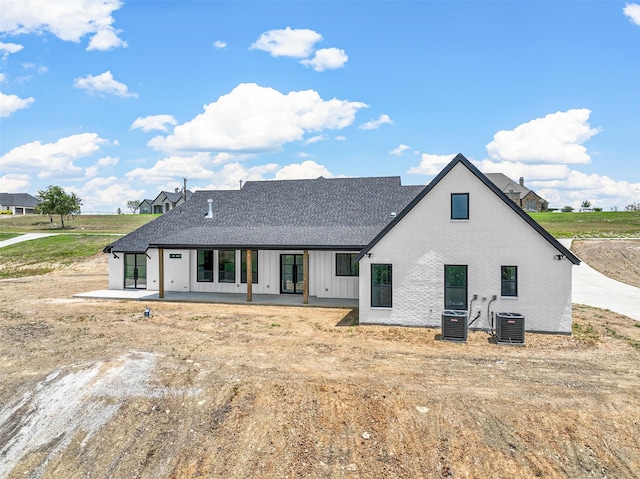 rear view of house with a patio and central AC unit