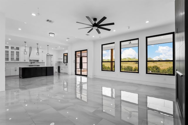 unfurnished living room with ceiling fan