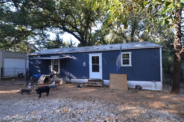 view of front facade with an outbuilding and a garage