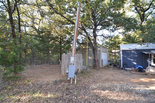 view of yard featuring an outbuilding and a garage