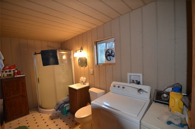 clothes washing area featuring washer and clothes dryer, wood walls, and wooden ceiling