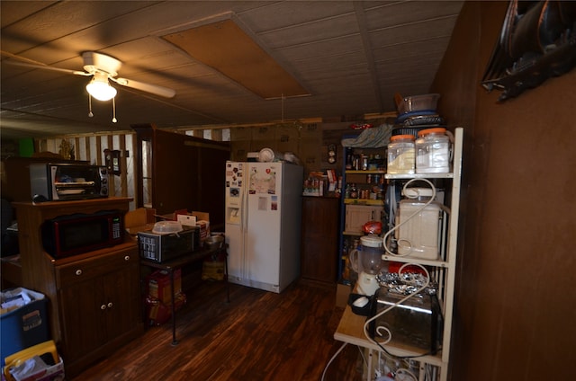 interior space with ceiling fan, dark hardwood / wood-style flooring, and white fridge with ice dispenser