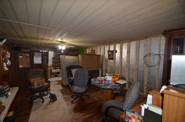 office area with hardwood / wood-style flooring, ceiling fan, and wood walls