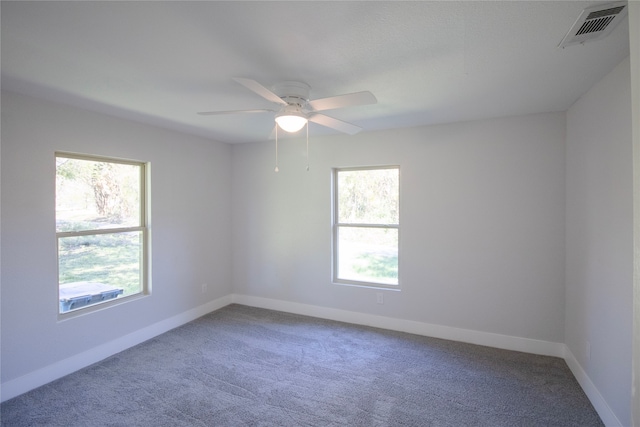 carpeted empty room featuring ceiling fan