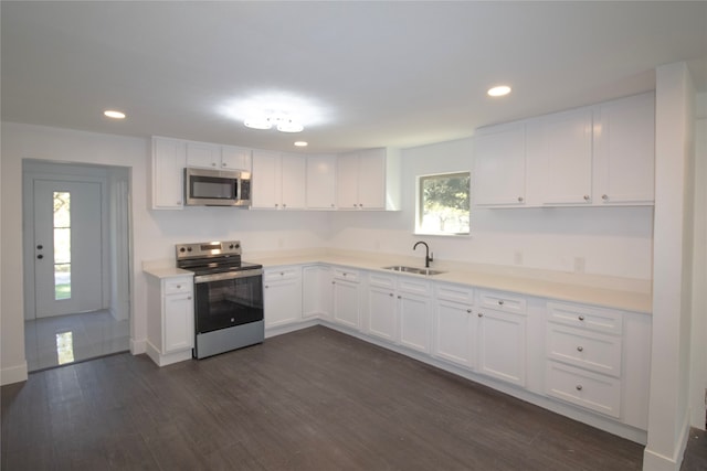 kitchen featuring dark hardwood / wood-style flooring, stainless steel appliances, sink, white cabinets, and plenty of natural light