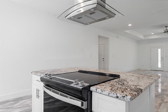 kitchen featuring white cabinets, stainless steel range with electric stovetop, and light stone counters