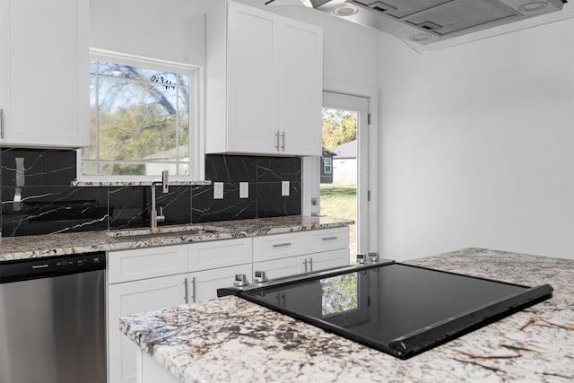 kitchen with light stone countertops, sink, stainless steel dishwasher, black electric cooktop, and white cabinets