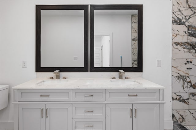 bathroom featuring vanity, toilet, and walk in shower