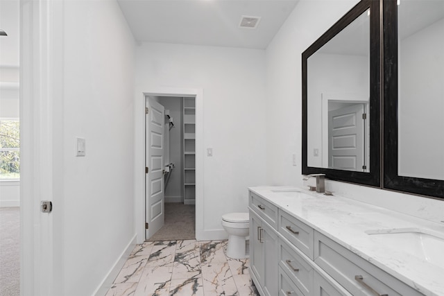 bathroom featuring vanity and toilet