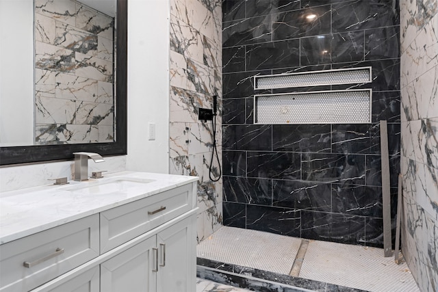 bathroom featuring vanity and a tile shower