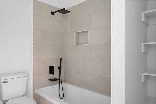 bathroom featuring toilet and tiled shower / bath