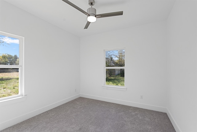 spare room featuring carpet and ceiling fan