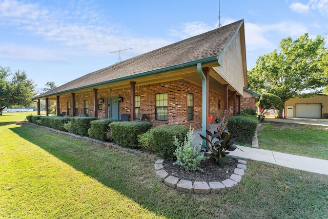 view of side of home with a garage, brick siding, and a lawn