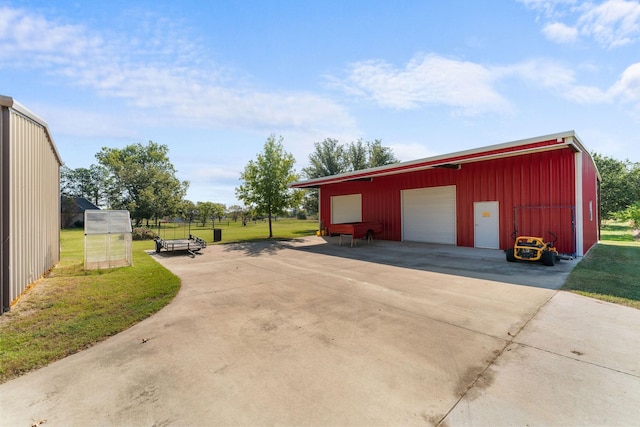 detached garage featuring fence