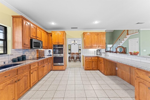 bathroom featuring tile patterned floors, toilet, tiled shower, vanity, and ornamental molding