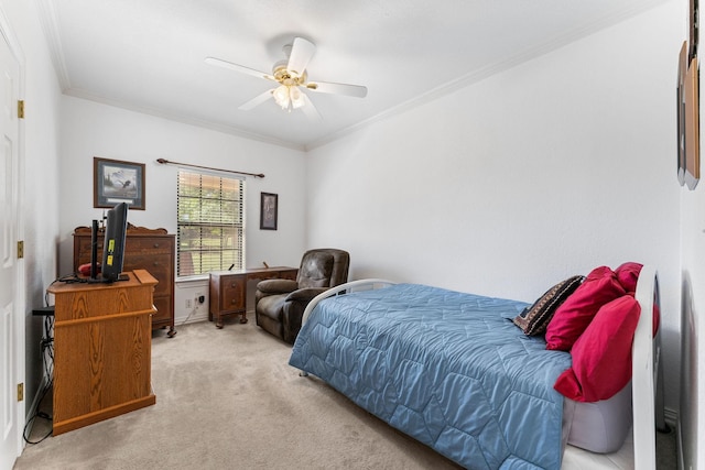 carpeted bedroom featuring ceiling fan and crown molding