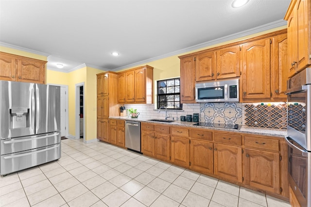 kitchen with light tile patterned floors, ornamental molding, appliances with stainless steel finishes, and a sink