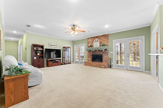 carpeted living area featuring a ceiling fan, visible vents, recessed lighting, crown molding, and a brick fireplace