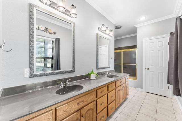 bathroom featuring vanity, tile patterned floors, a shower with door, and crown molding