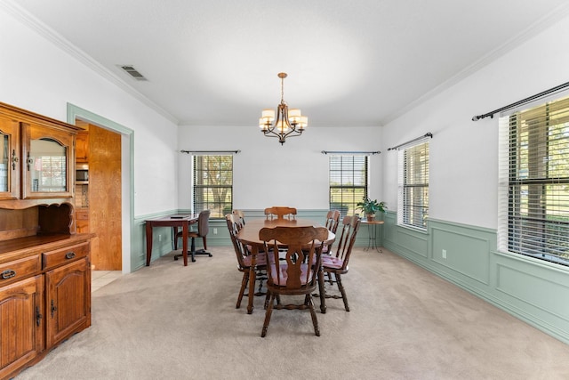 dining space featuring light carpet, a notable chandelier, and ornamental molding