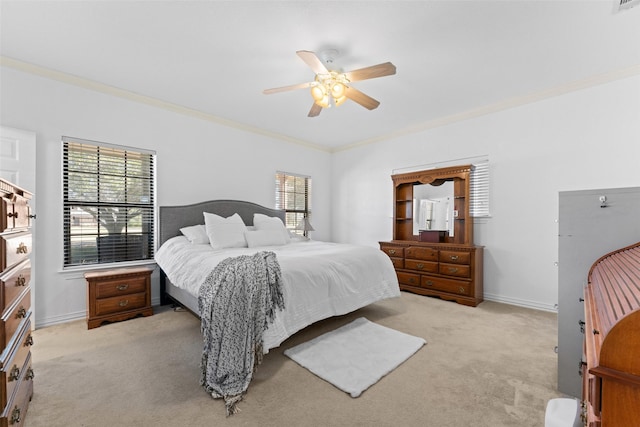 bedroom featuring ceiling fan, baseboards, light colored carpet, and ornamental molding