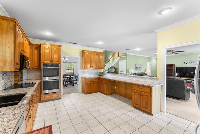 kitchen with decorative backsplash, ceiling fan, stainless steel appliances, and ornamental molding