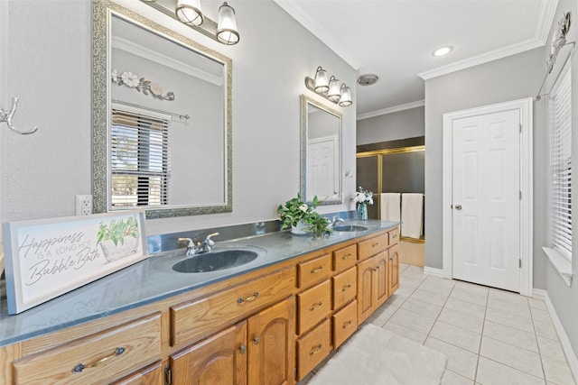 bathroom with double vanity, ornamental molding, tile patterned flooring, a shower stall, and a sink