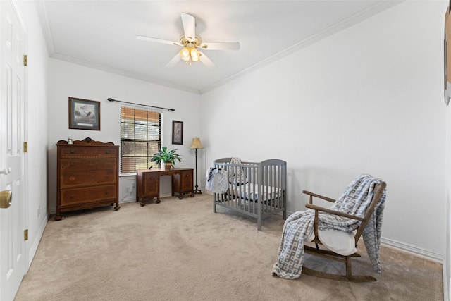 bedroom with ceiling fan, baseboards, crown molding, and carpet