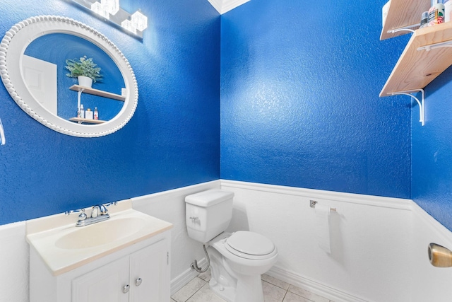 bathroom featuring tile patterned floors, vanity, and toilet