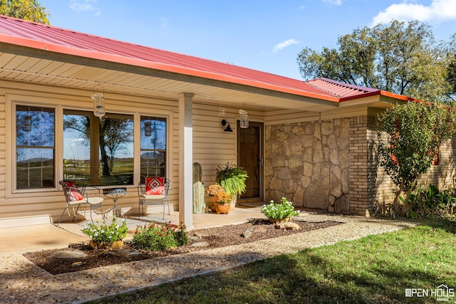 view of exterior entry with a porch