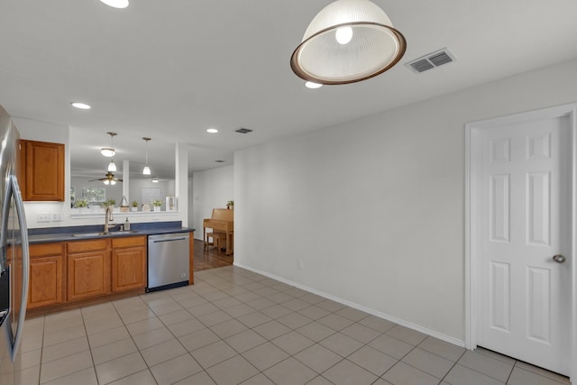 kitchen featuring dishwasher, light tile patterned floors, hanging light fixtures, and sink