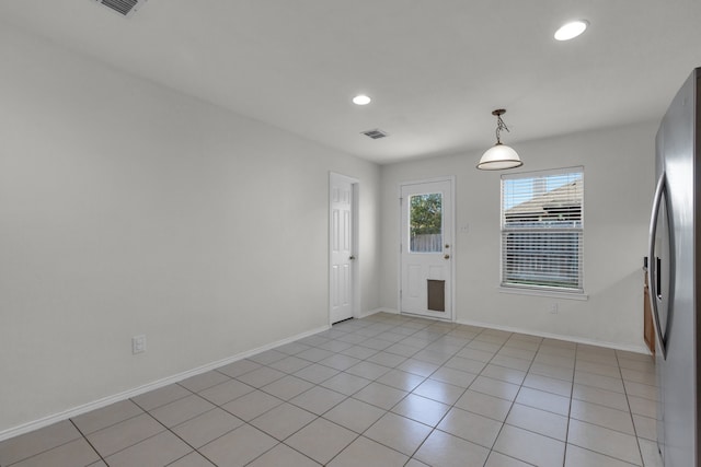 spare room featuring light tile patterned flooring