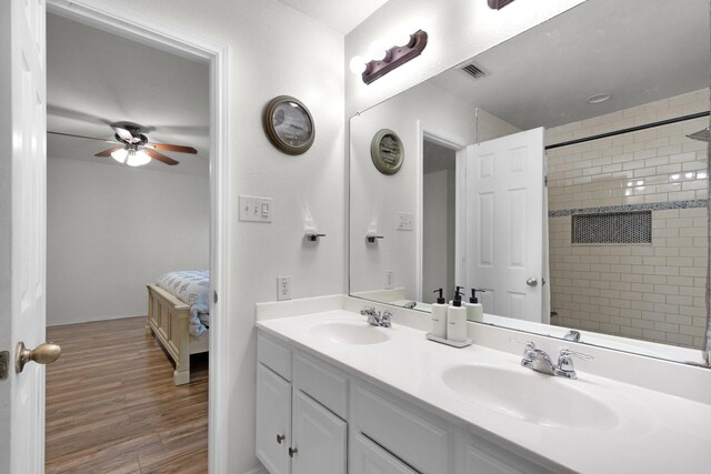 bathroom with ceiling fan, vanity, and wood-type flooring