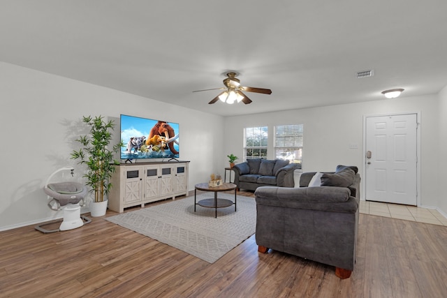 living room featuring ceiling fan and light wood-type flooring