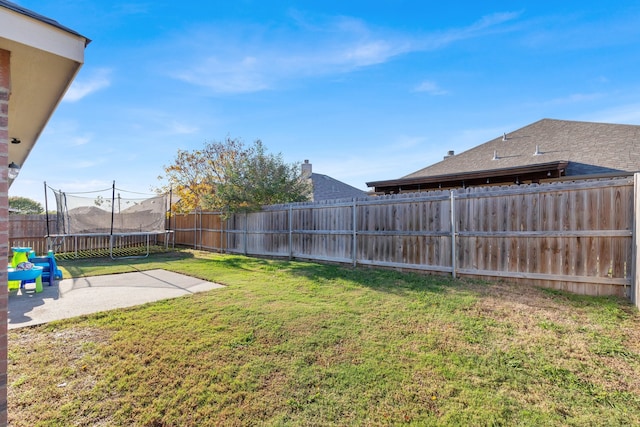 view of yard featuring a patio and a trampoline