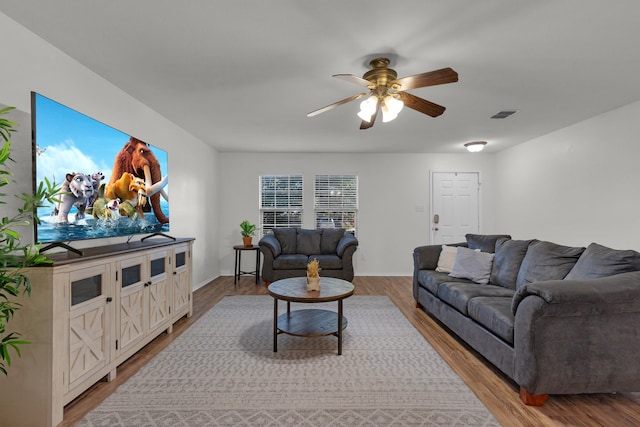 living room with hardwood / wood-style flooring and ceiling fan