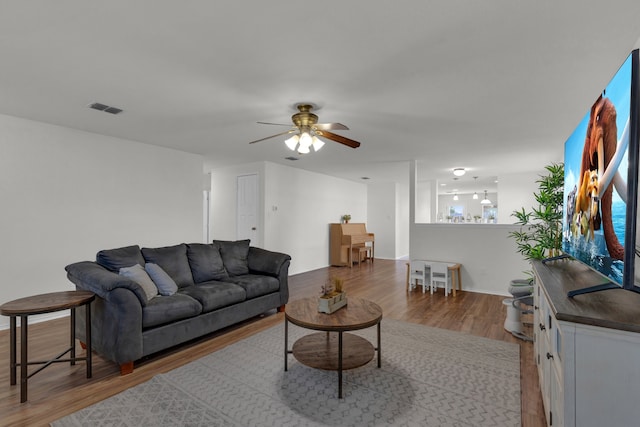 living room with hardwood / wood-style floors and ceiling fan