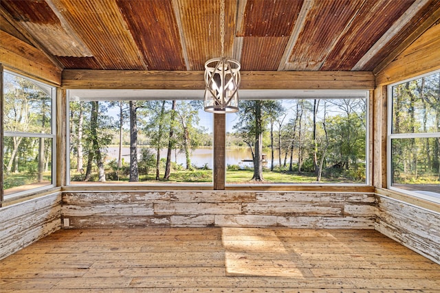 unfurnished sunroom with a water view, wooden ceiling, vaulted ceiling, and a notable chandelier