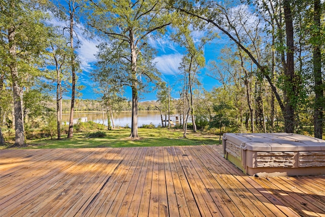 wooden terrace with a lawn and a water view