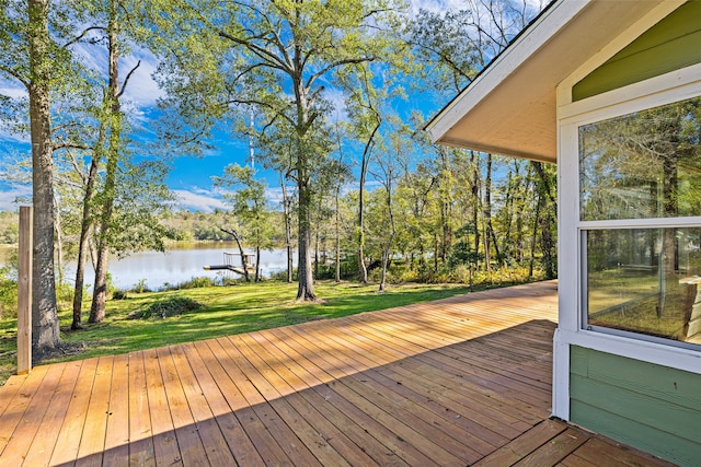 deck featuring a lawn and a water view