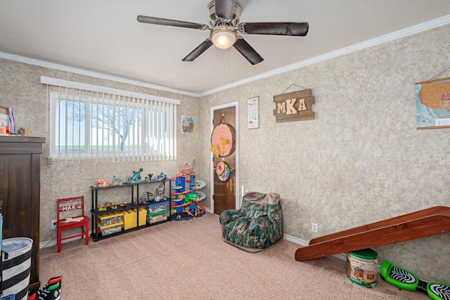 game room with ceiling fan, carpet floors, and ornamental molding