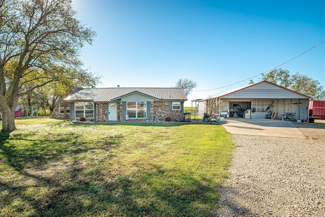 ranch-style house with a carport, a garage, and a front yard