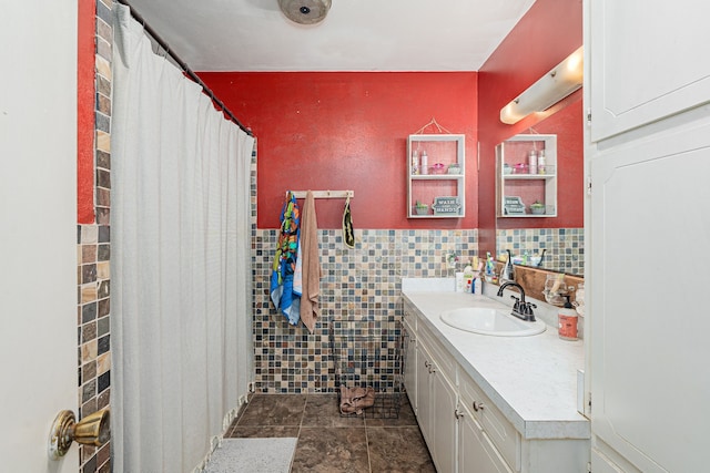 bathroom featuring tile patterned flooring, vanity, and tile walls